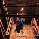 Een screenshot uit Dark Souls 3, waar een speler een lift gebruikt als één van de vele shortcuts