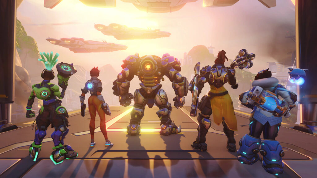 Lucio, Tracer, Reinhard, Brigitte en Mei staan op een rij, samen als een team voor een potje Overwatch 2.